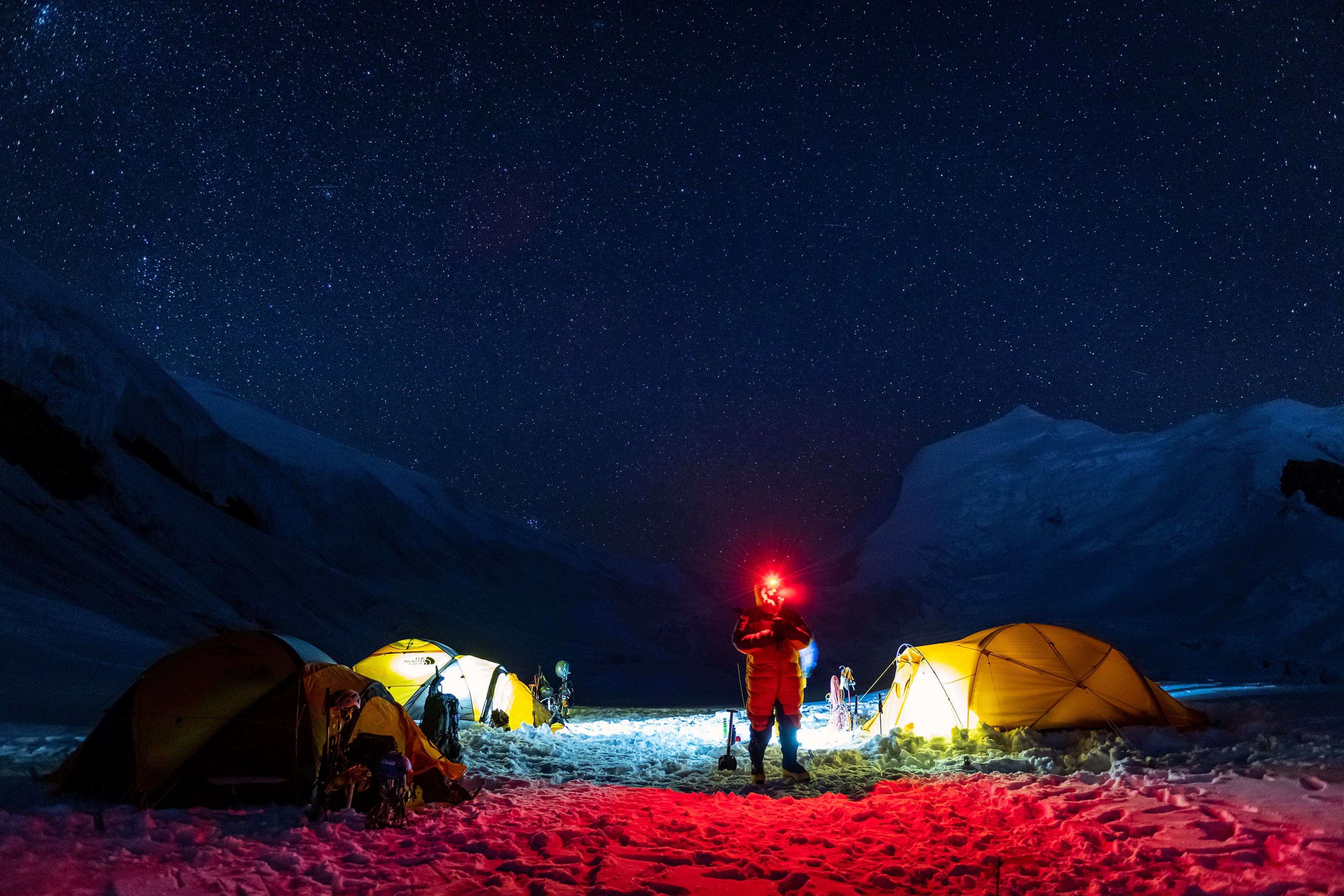 High-altitude camp at night under a starry sky
